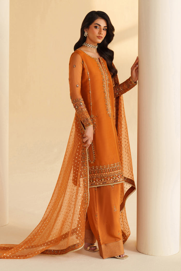 Side view of NAQSHI burnt orange formal dress highlighting flowing dupatta, elegant cut, and polished occasion wear look