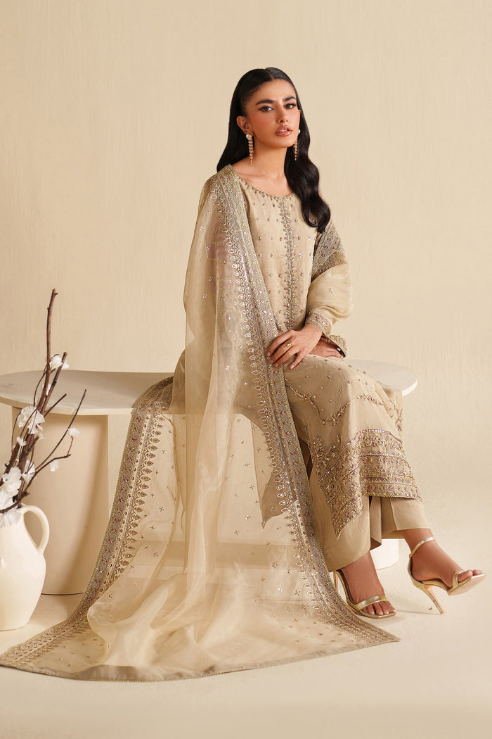 Close-up of NAQSHI ivory beige formal dress showing fine embroidery on fabric and sleeves with premium stitched quality