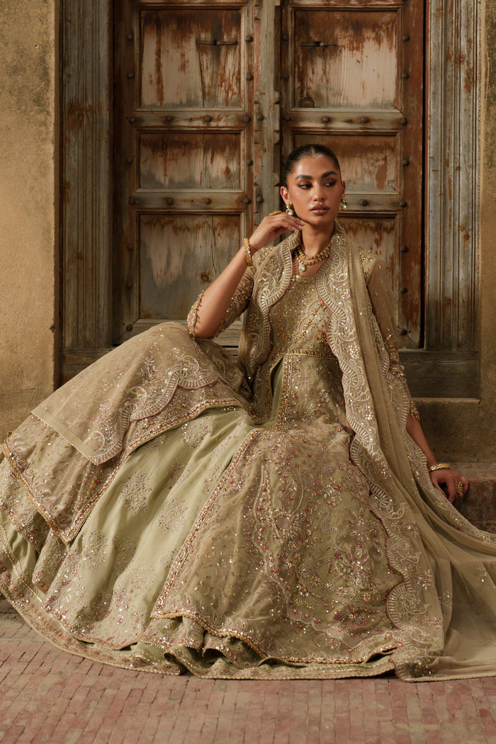 Yunra sand brown evening outfit seated pose showing embellished Net bodice and wide layered maxi.