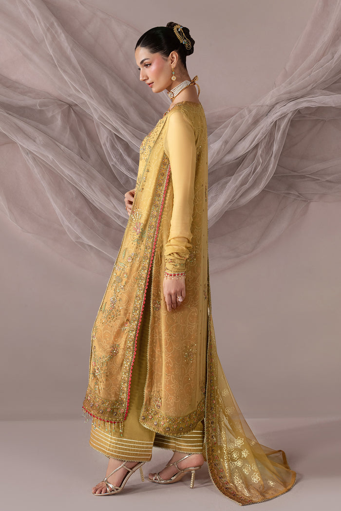 Side view of Zahwa showing the golden embroidered Crinkle shirt, flowing Net dupatta and coordinated culotte silhouette.