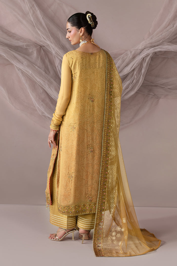Back view of Zahwa highlighting the long golden shirt, extended sleeves and draped Net dupatta with soft fall.