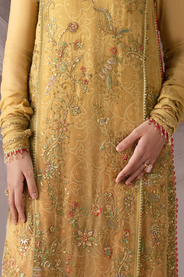 Close-up of Zahwa showing the embroidered boat neckline, sequins, highlighted panel detailing and golden shirt texture.