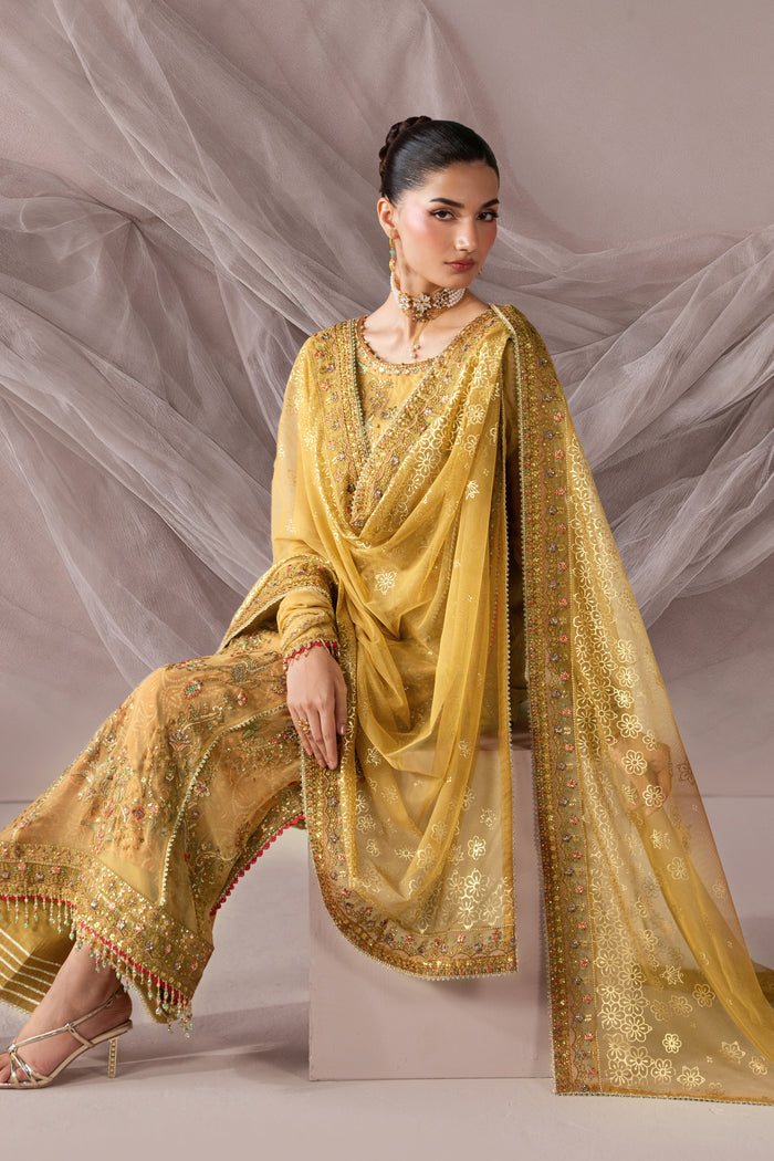 Seated view of Zahwa golden semi-formal outfit showing the embroidered shirt, draped dupatta and coordinated lower.