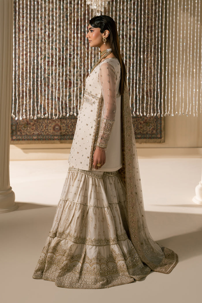 Side profile of Zaleena formal Nikkah outfit showing soft fall of layered gharara and clean silhouette, graceful ready to wear wedding outfit.