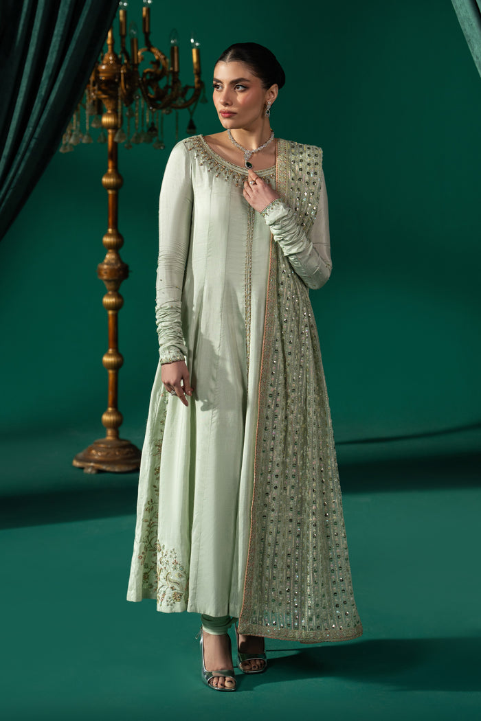 Zarqand pistachio 3-piece semi-formal outfit with panelled frock, PK Raw Silk churidar pajama and embroidered Net dupatta in a full front view.
