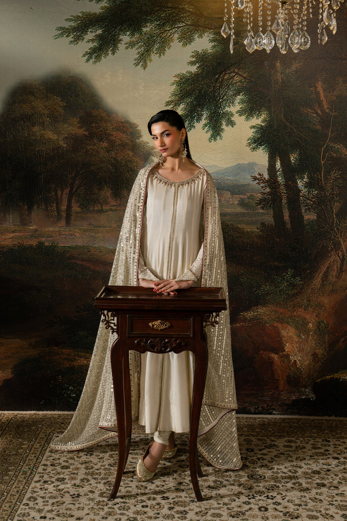 Front view of Zarsanga highlighting the flowing Indian Raw Silk frock, boat neckline and softly draped Net dupatta.