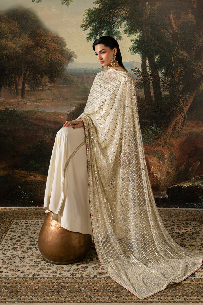 Seated view of Zarsanga showing the off-white flared frock and embroidered Net dupatta with flowing border detail.