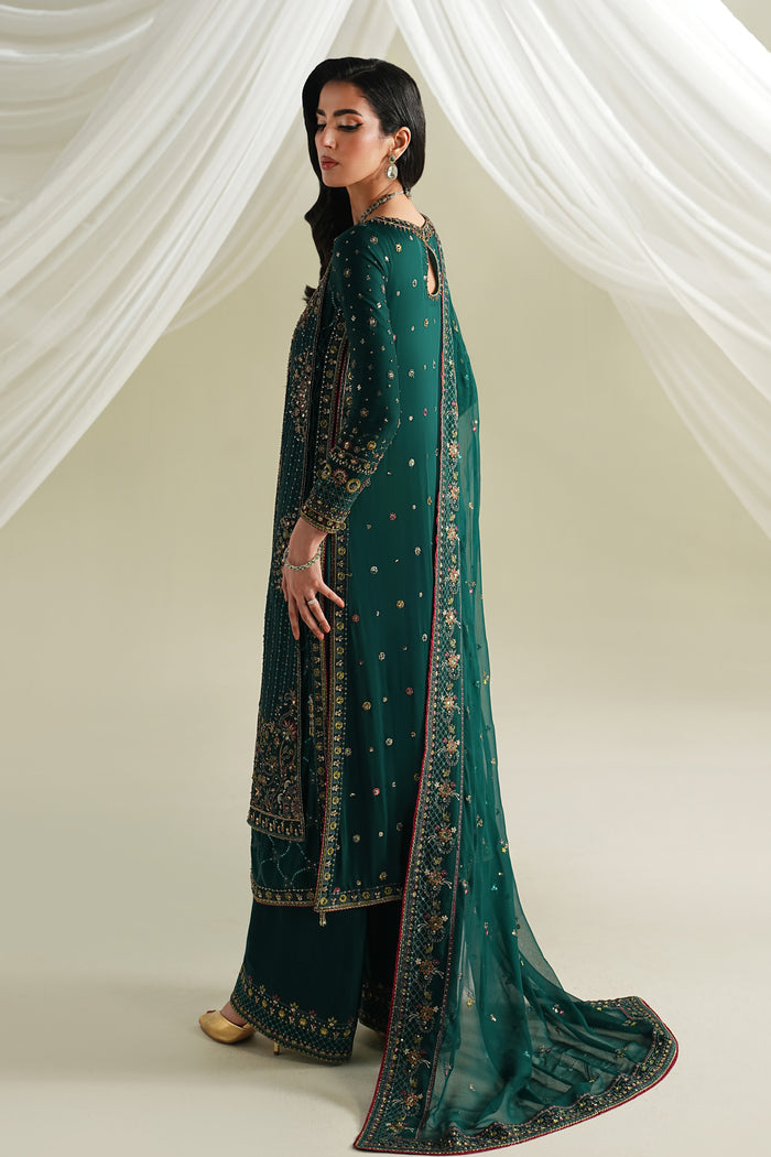 Bottle green long gown style shirt side view with culotte and crinkle dupatta, soft flowy formal outfit for festive occasions.