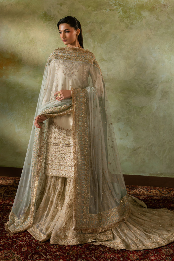 Full standing pose of Zemira formal Nikkah outfit highlighting embroidered shirt, balanced silhouette and bordered net dupatta styling, modest ready to wear wedding attire.