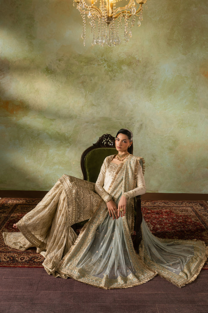 Seated look of Zemira Nikkah outfit featuring wide spread farshi gharara and long dupatta trail, calm and elegant ready made wedding dress.