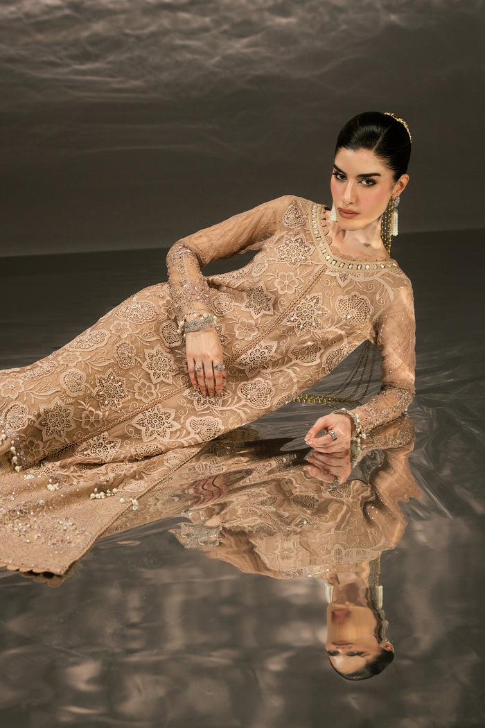 Seated view of Zita highlighting the embroidered Organza shirt, sequin detailing and flowing wide flare pants.