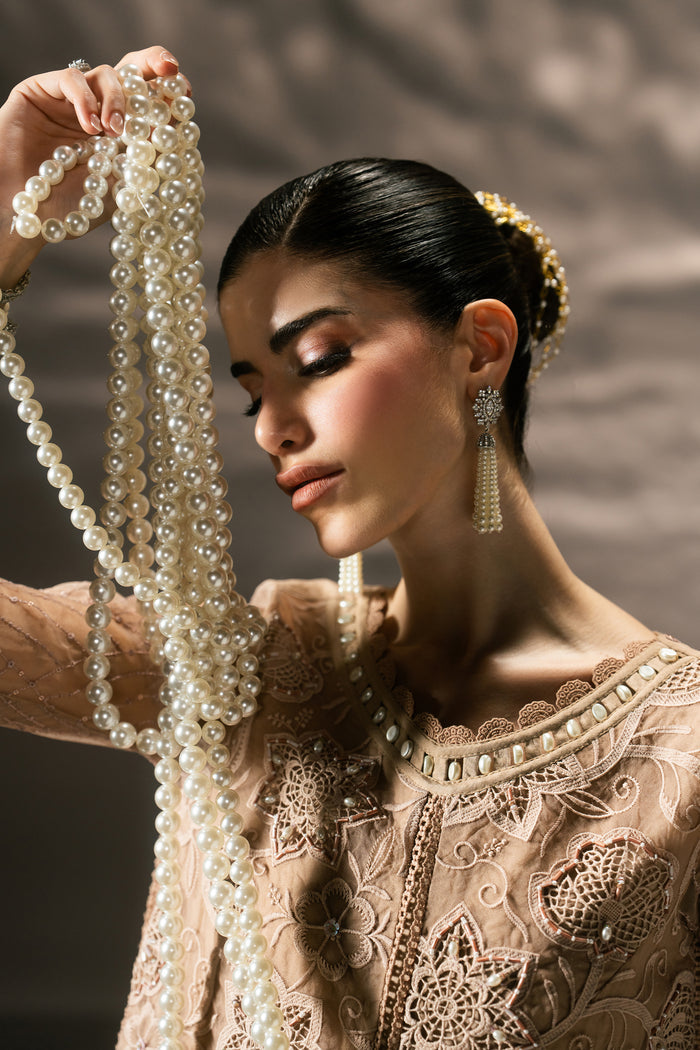 Close-up of Zita showing the textured neckline, embroidery, sequins and fitted Organza sleeve detailing.